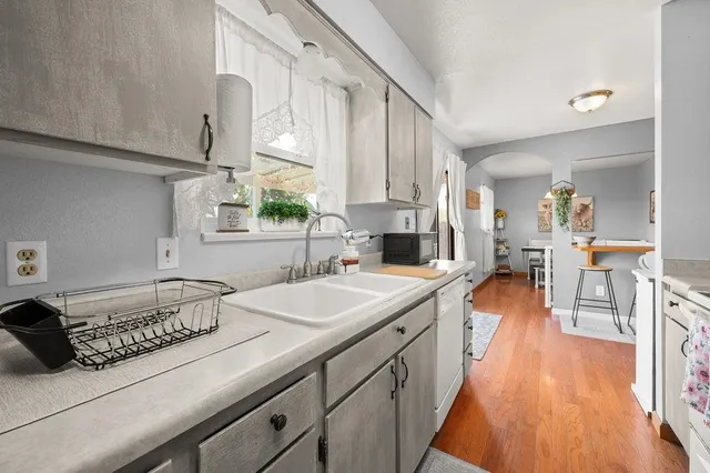 a spacious bathroom with a double vanity sink a mirror and a bathtub