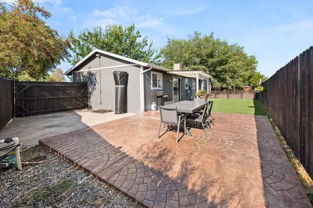 a view of a house with a yard and sitting area