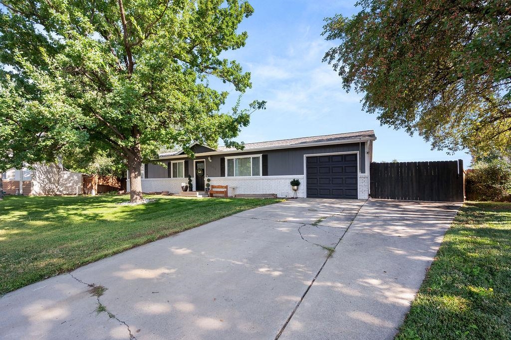 3022 Country Road Grand Junction, CO 81504 - Photo 3 of 23 a front view of a house with a yard and a garage