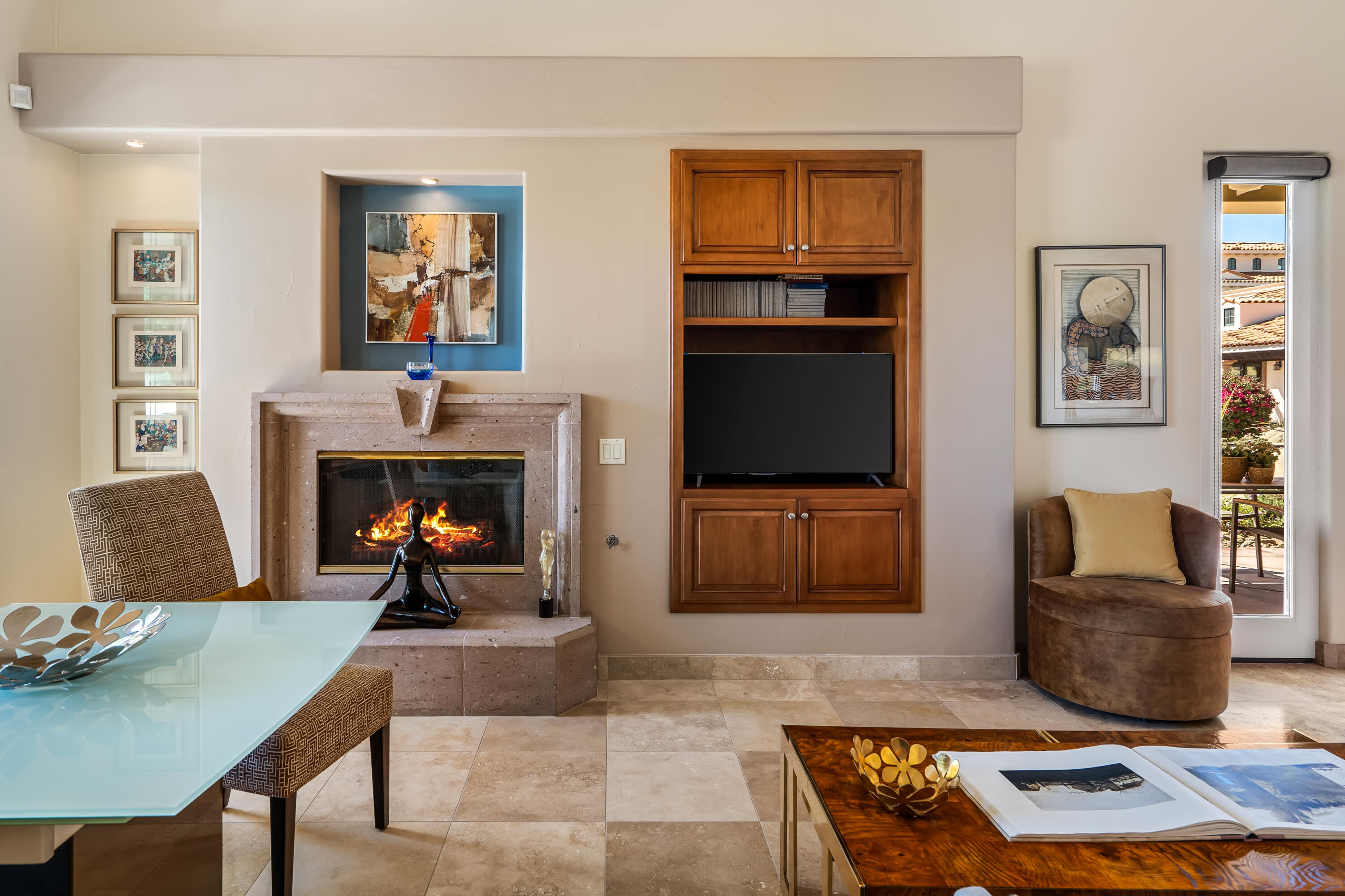 106 Piazza Perrone Palm Desert, CA 92260 - Photo 16 of 68 a living room with furniture a flat screen tv and a fireplace