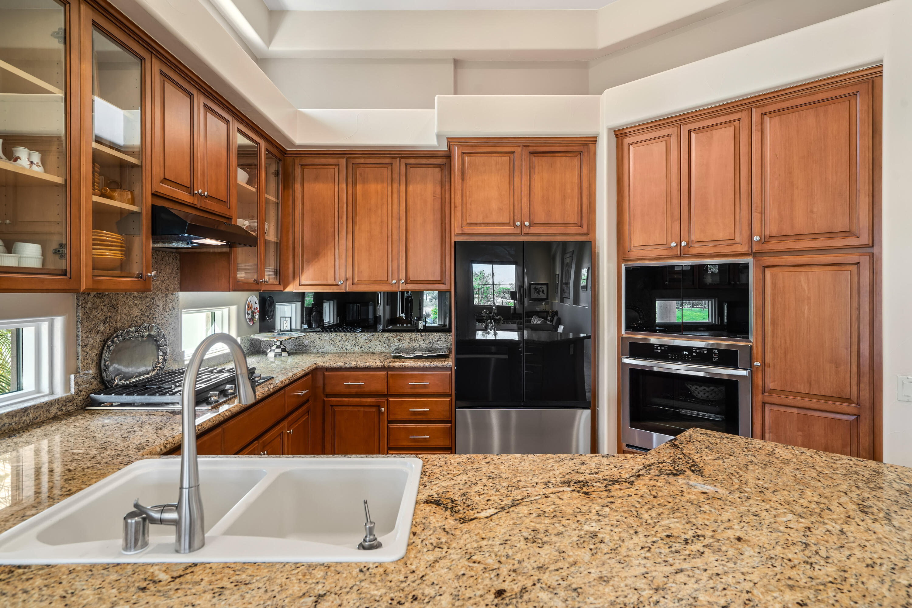 106 Piazza Perrone Palm Desert, CA 92260 - Photo 23 of 68 a kitchen with granite countertop a refrigerator and a sink