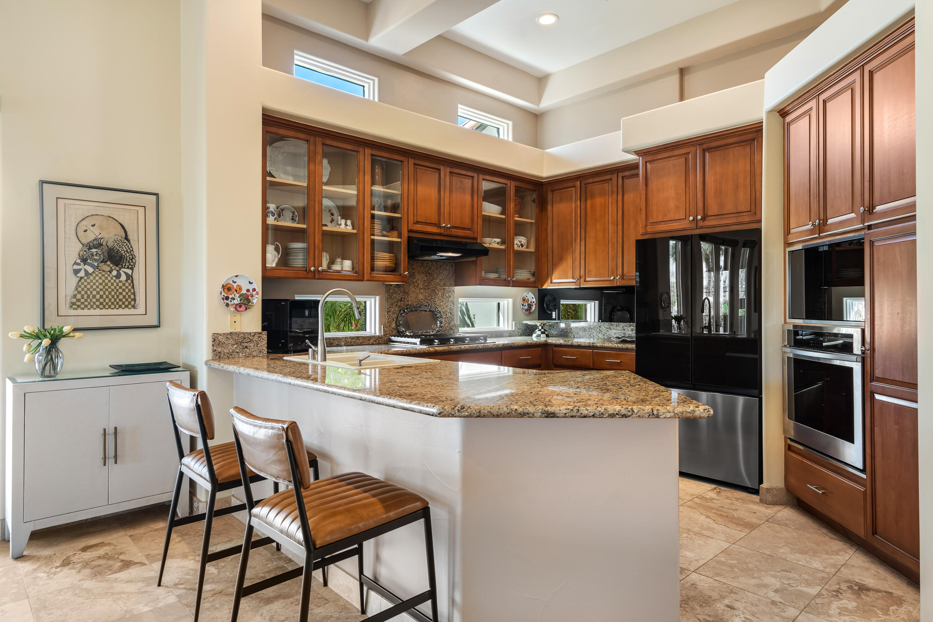 106 Piazza Perrone Palm Desert, CA 92260 - Photo 24 of 68 a kitchen with stainless steel appliances granite countertop a refrigerator and a stove top oven
