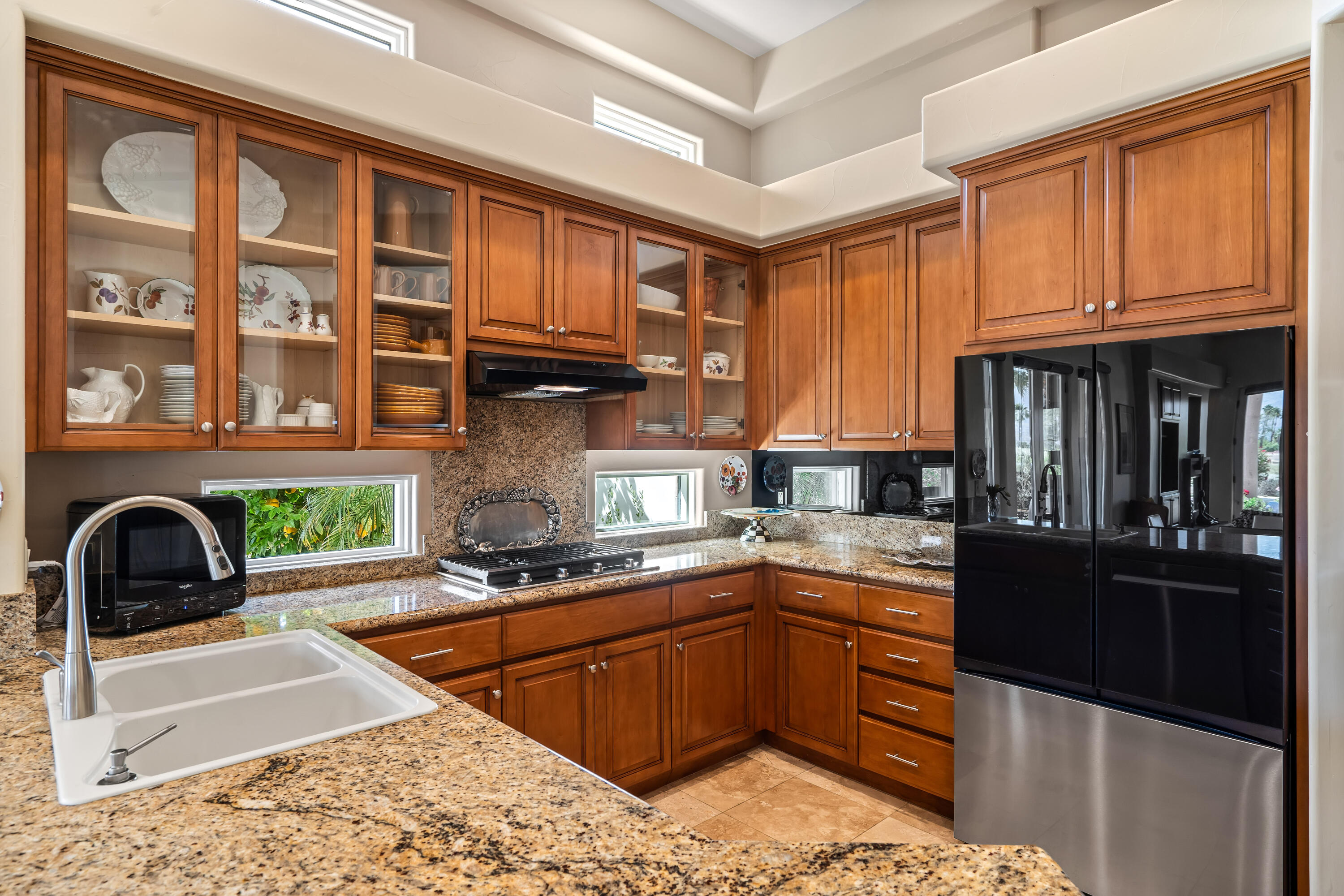 106 Piazza Perrone Palm Desert, CA 92260 - Photo 25 of 68 a kitchen with stainless steel appliances granite countertop a stove a sink and a microwave