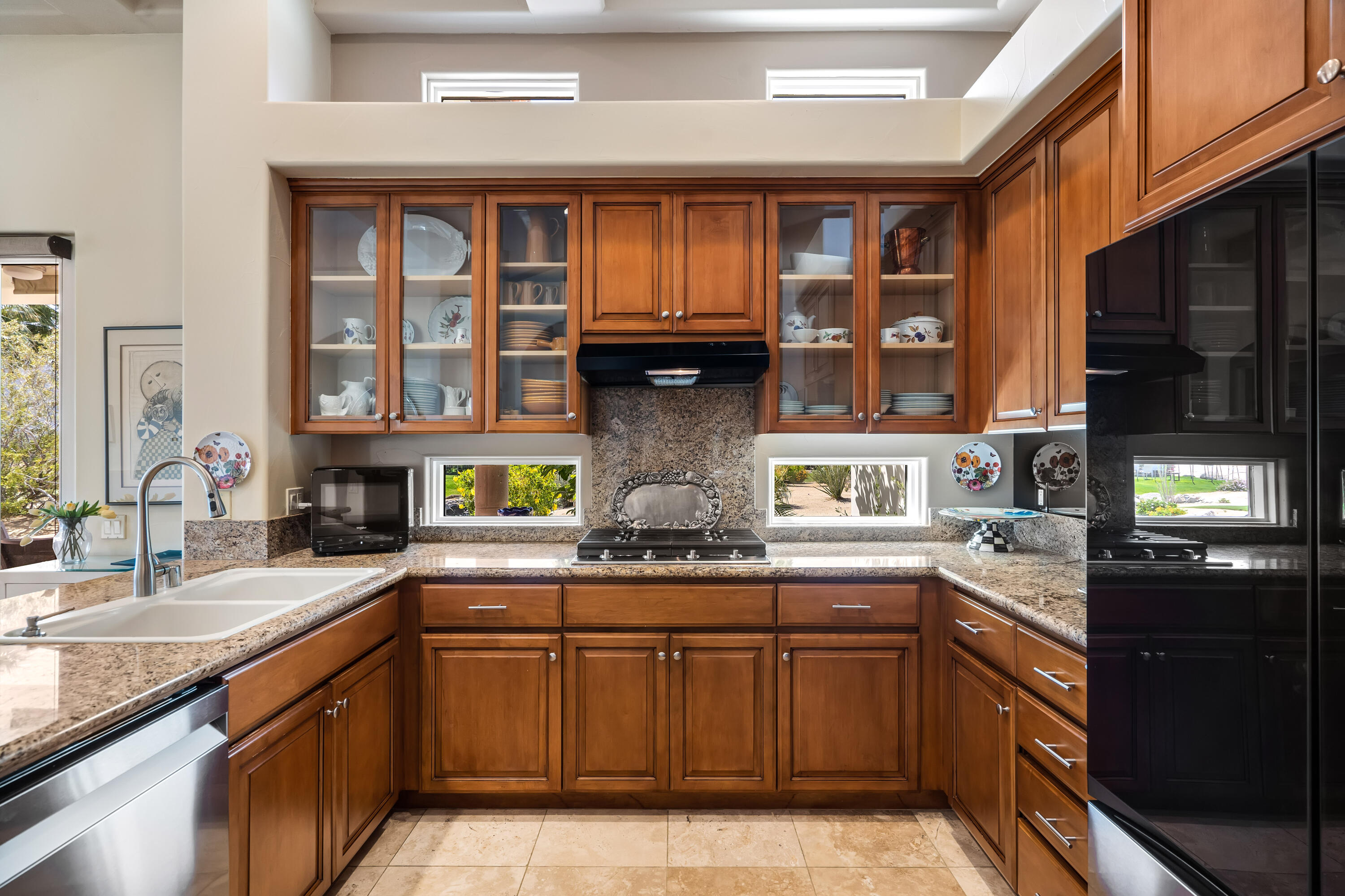 106 Piazza Perrone Palm Desert, CA 92260 - Photo 26 of 68 a kitchen with stainless steel appliances granite countertop a sink and cabinets
