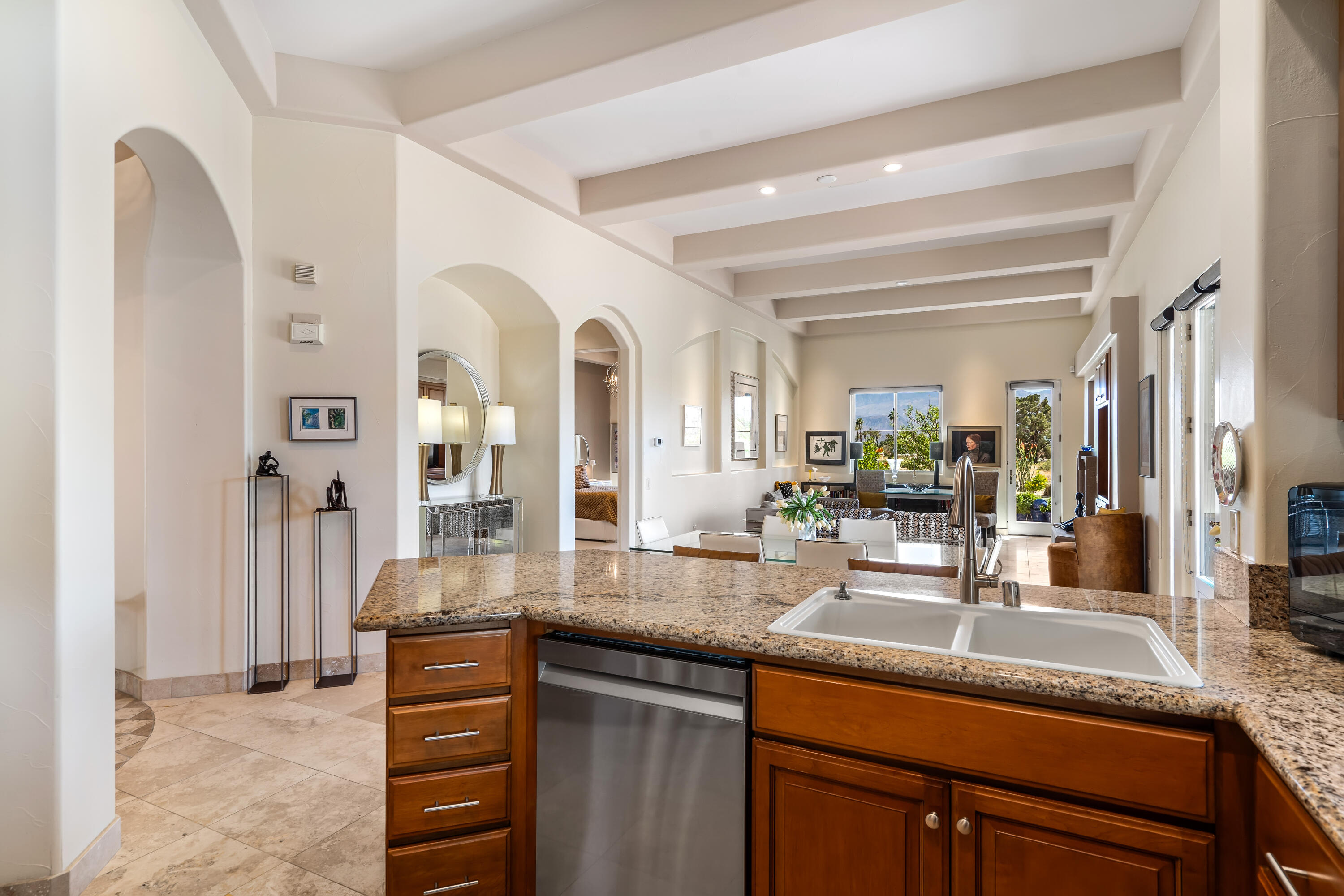 106 Piazza Perrone Palm Desert, CA 92260 - Photo 27 of 68 a kitchen with granite countertop a sink and cabinets