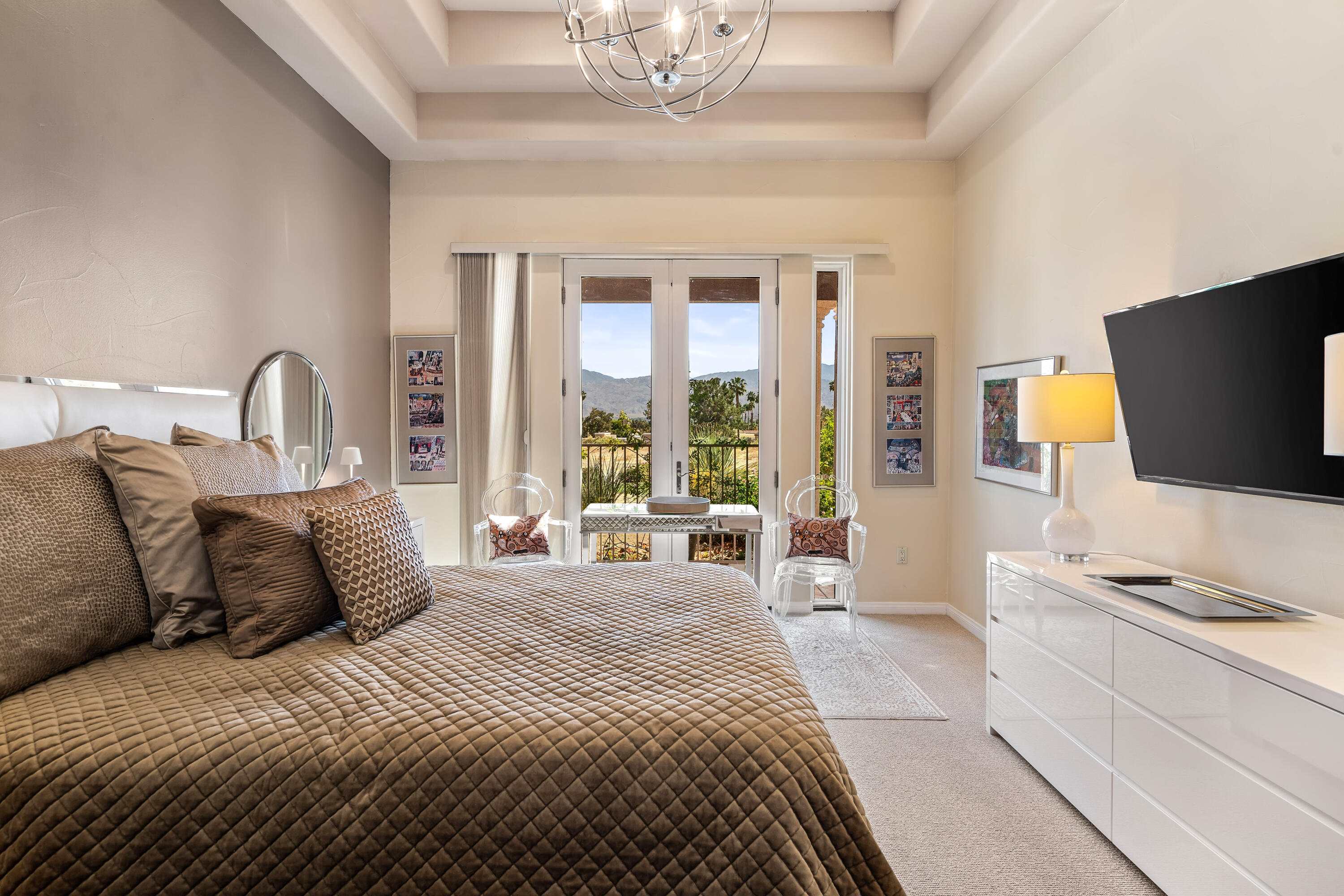 106 Piazza Perrone Palm Desert, CA 92260 - Photo 29 of 68 a bedroom with a large bed and a flat screen tv