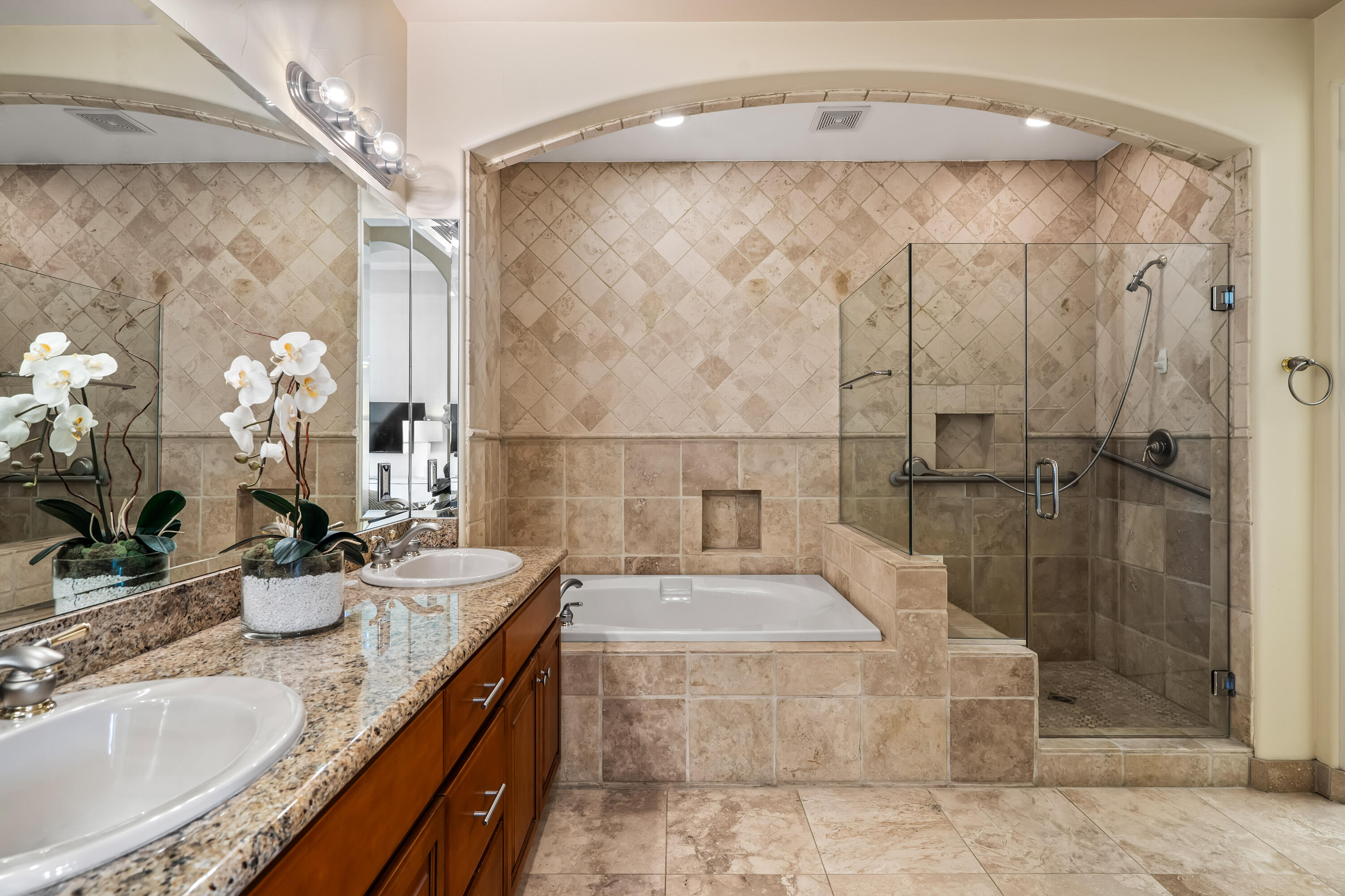 106 Piazza Perrone Palm Desert, CA 92260 - Photo 32 of 68 a bathroom with a granite countertop shower a sink and a mirror