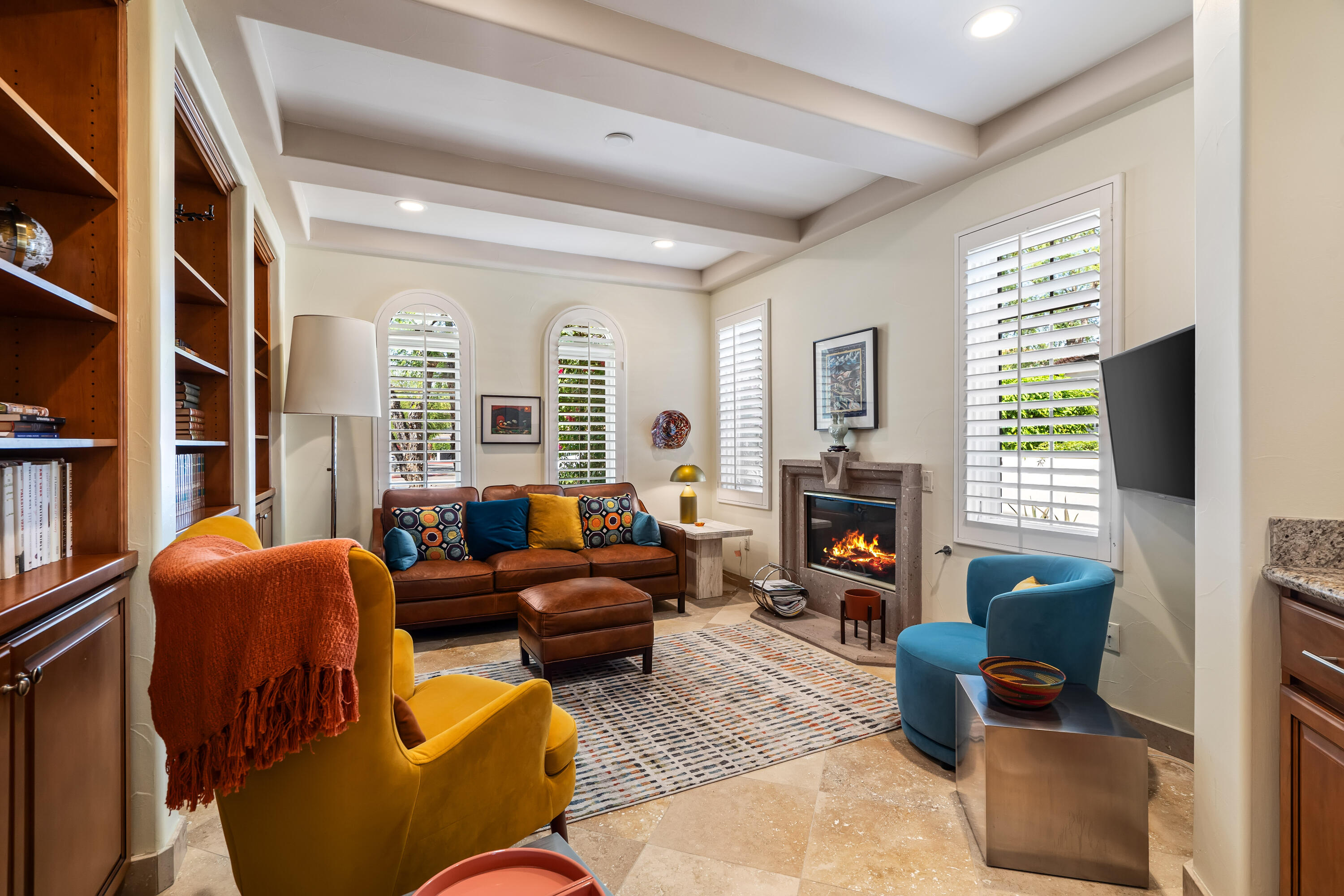 106 Piazza Perrone Palm Desert, CA 92260 - Photo 36 of 68 a living room with furniture a fireplace and a flat screen tv