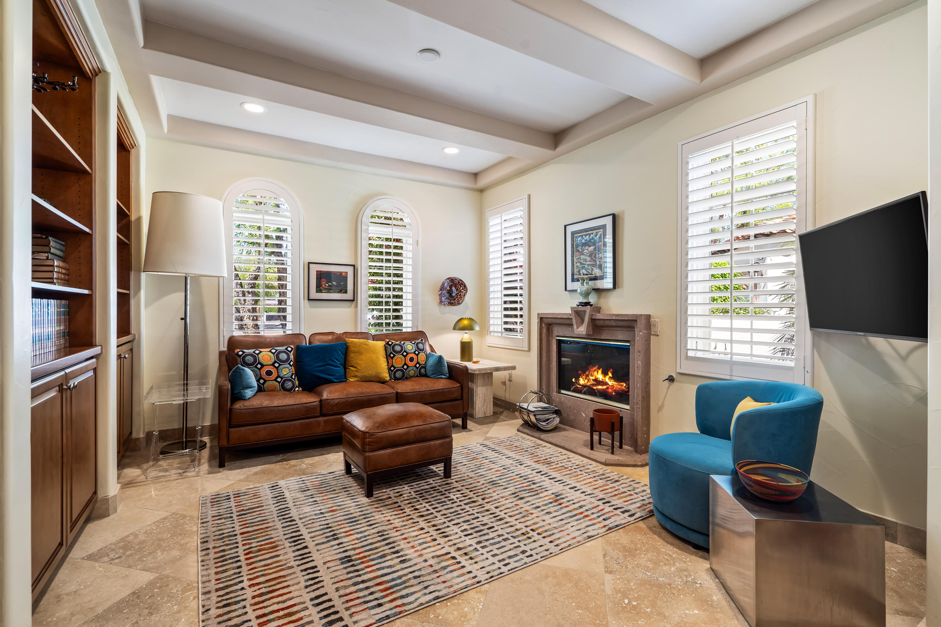 106 Piazza Perrone Palm Desert, CA 92260 - Photo 37 of 68 a living room with furniture a flat screen tv and a fireplace