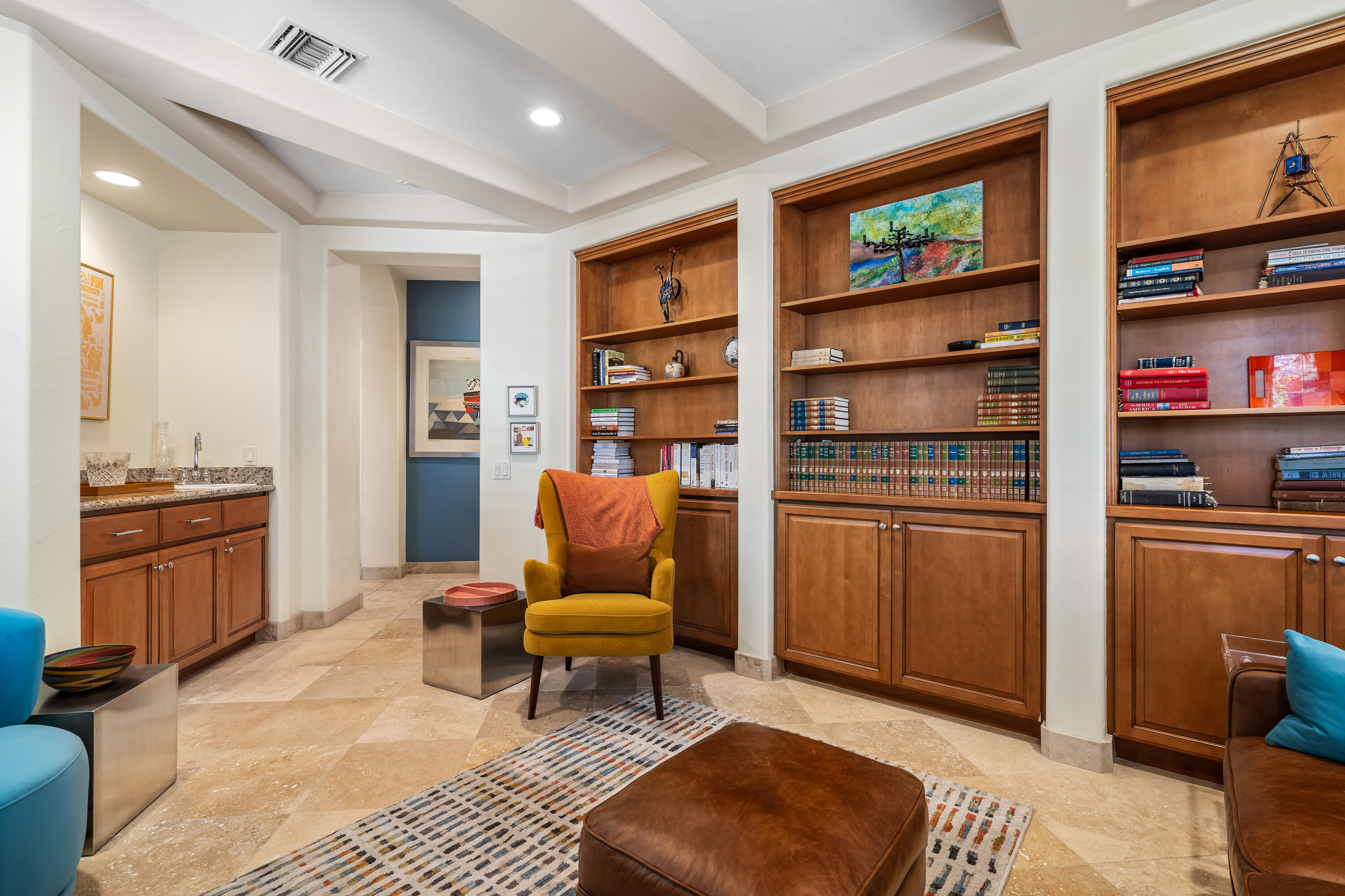 106 Piazza Perrone Palm Desert, CA 92260 - Photo 39 of 68 a living room with furniture a rug and a kitchen view