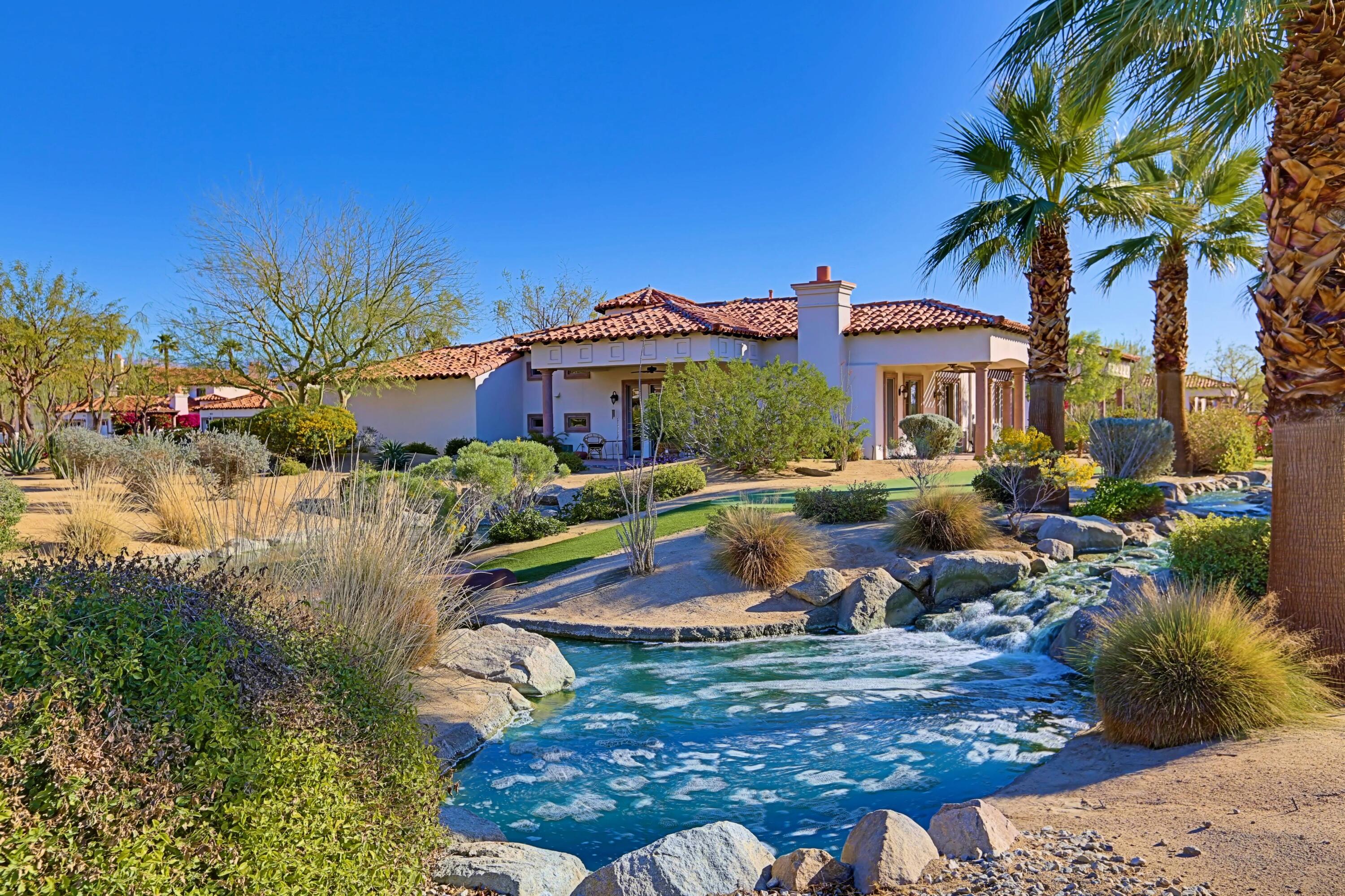 106 Piazza Perrone Palm Desert, CA 92260 - Photo 4 of 68 a view of a lake with a house in the background