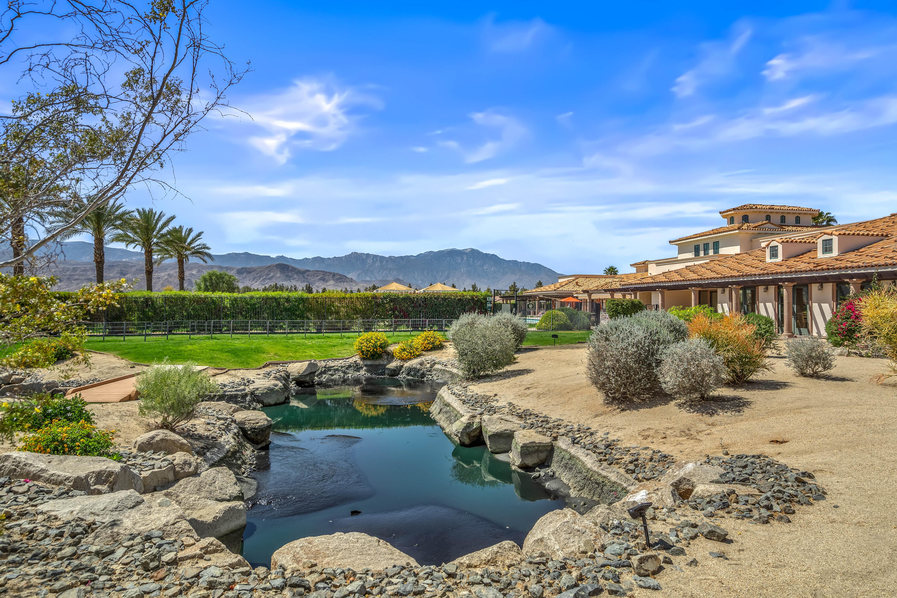 106 Piazza Perrone Palm Desert, CA 92260 - Photo 52 of 68 a view of a lake with a yard