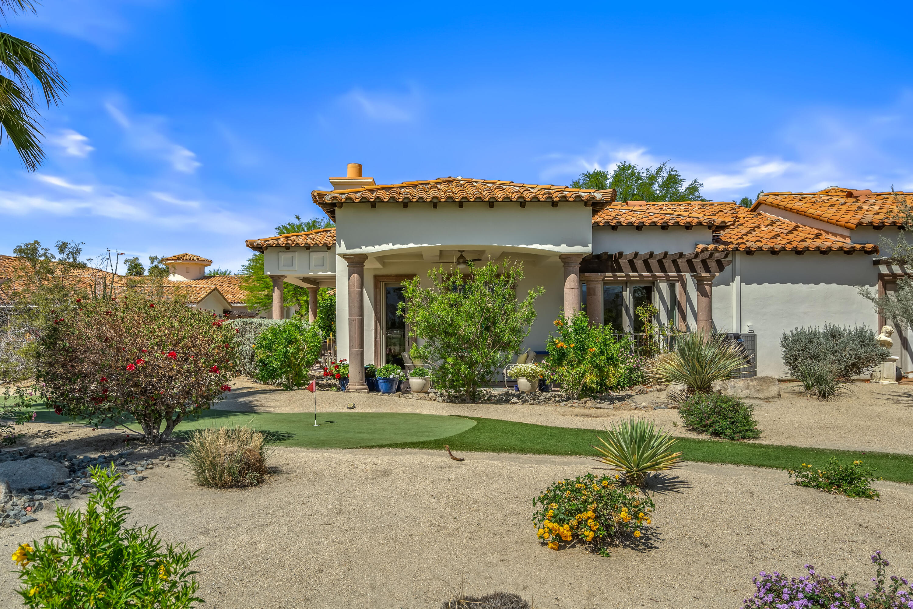 106 Piazza Perrone Palm Desert, CA 92260 - Photo 57 of 68 a front view of a house with a yard