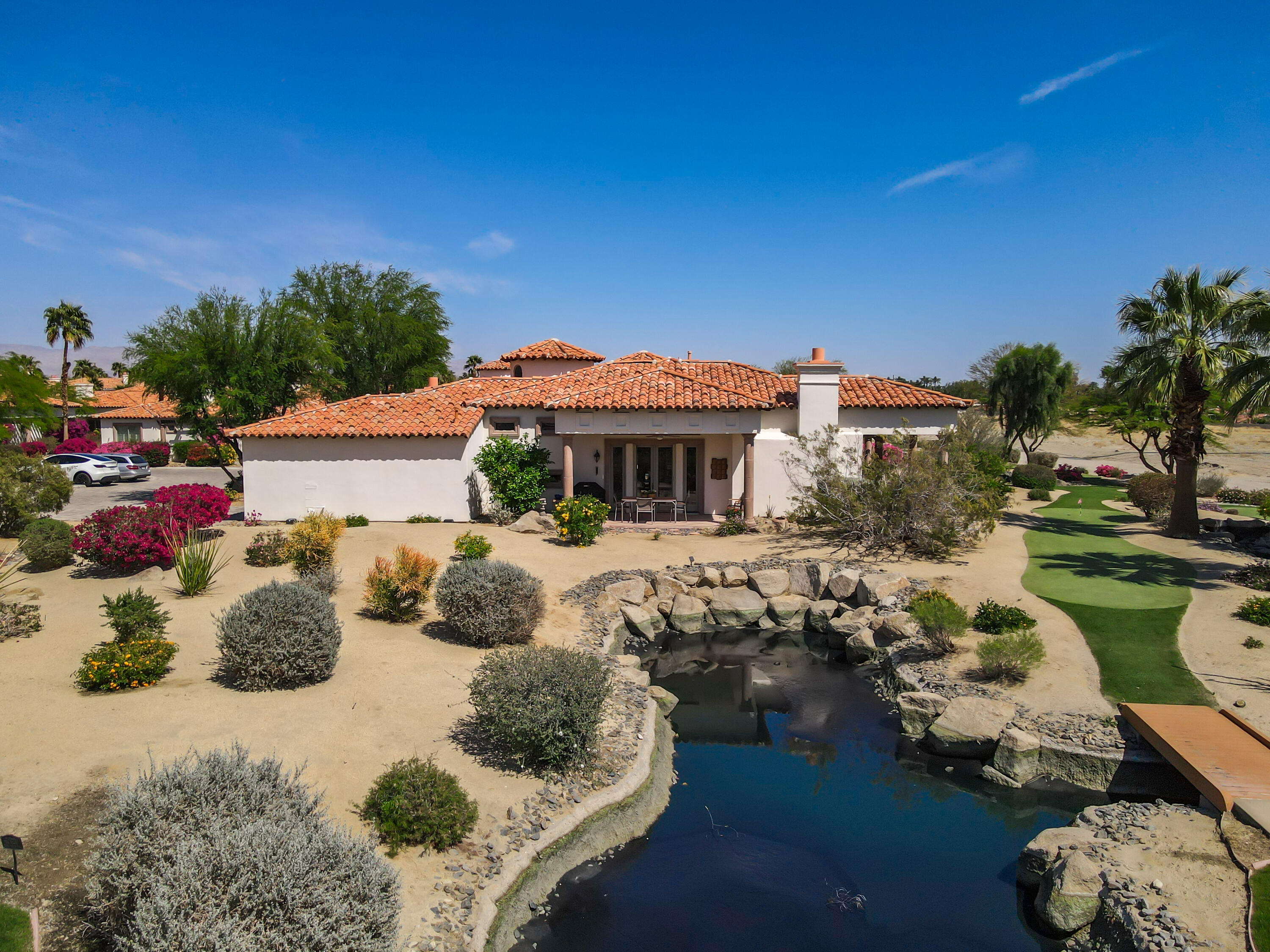 106 Piazza Perrone Palm Desert, CA 92260 - Photo 66 of 68 a view of a house with swimming pool and sitting area