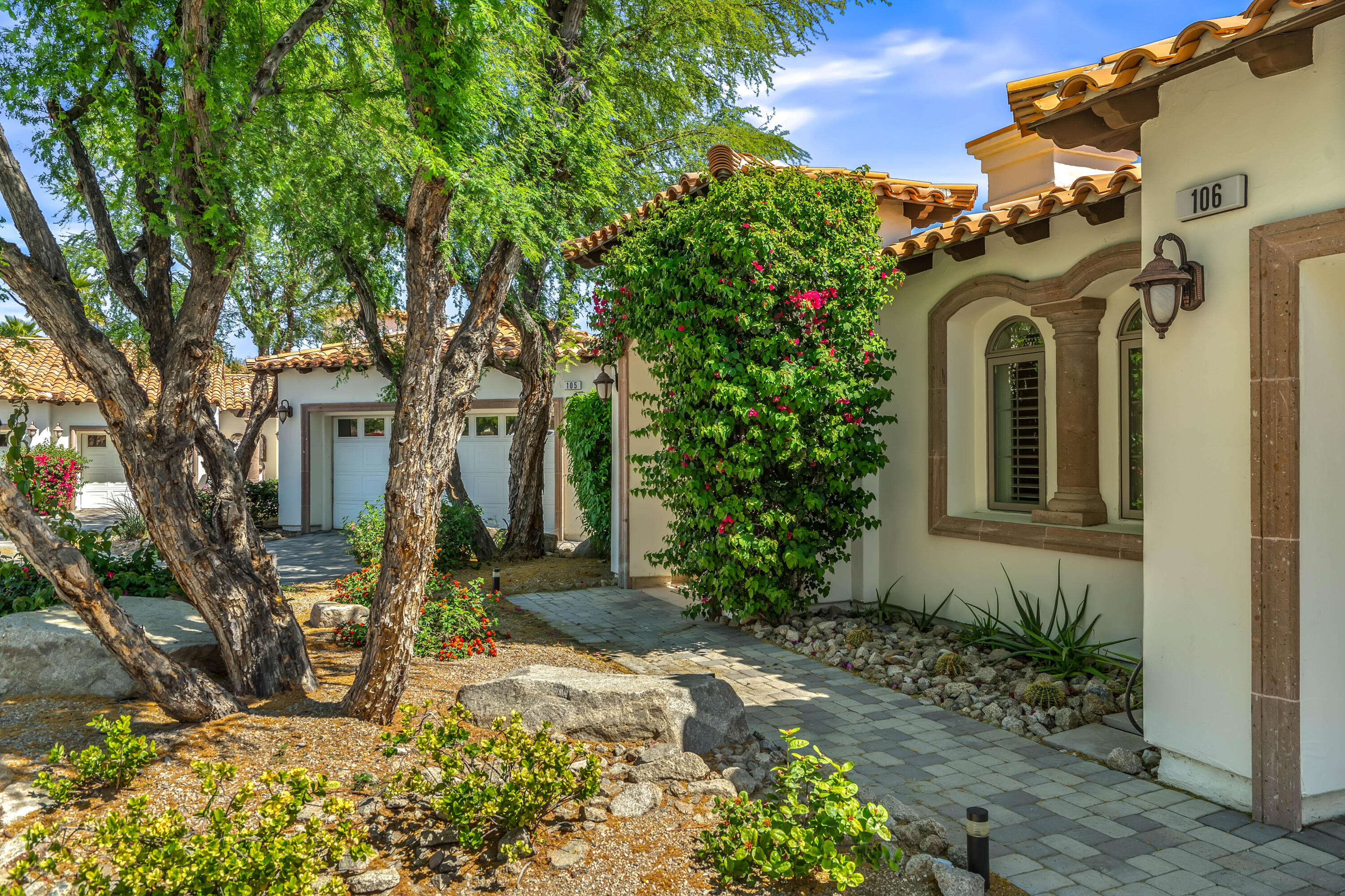 106 Piazza Perrone Palm Desert, CA 92260 - Photo 7 of 68 a front view of a house with garden