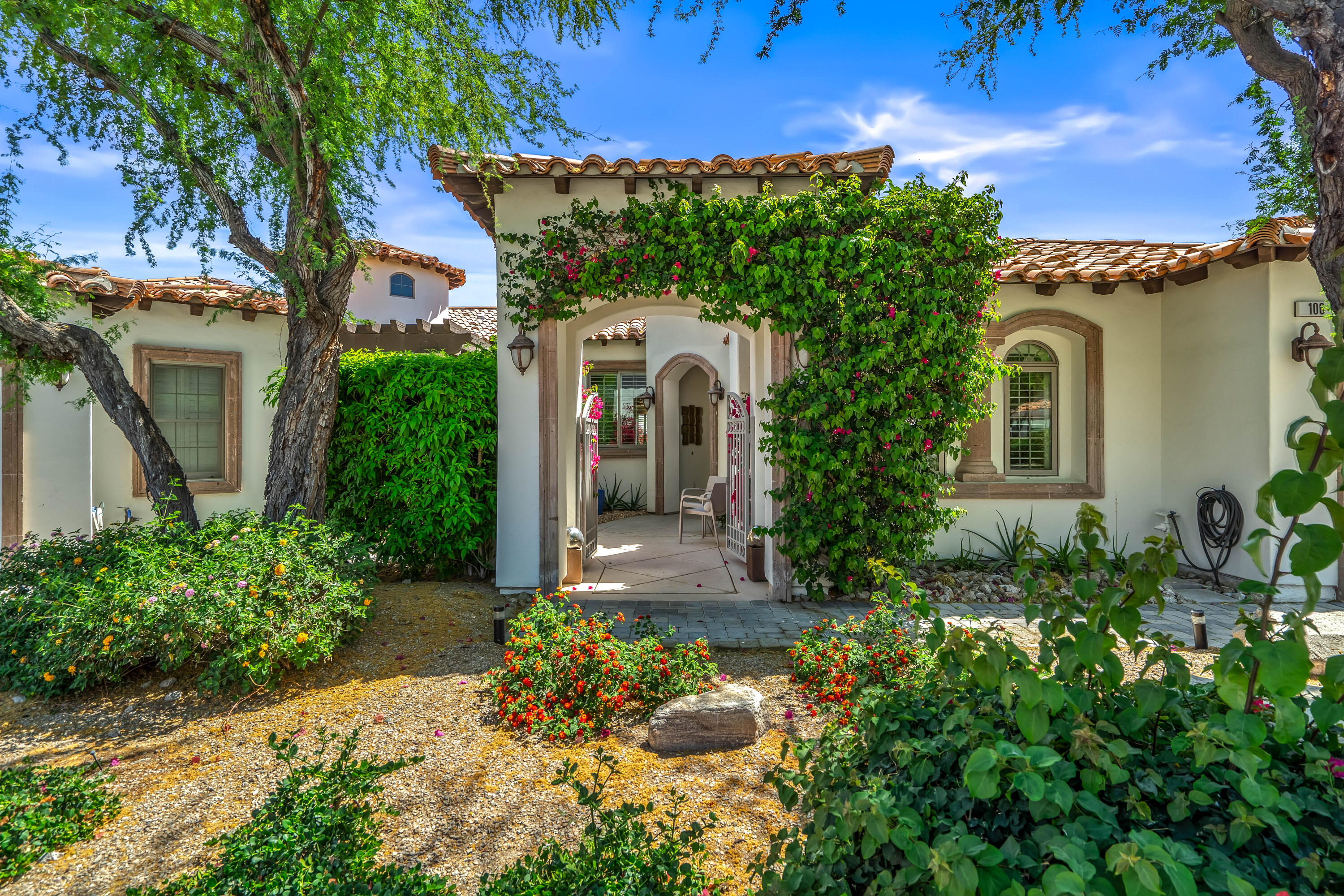 106 Piazza Perrone Palm Desert, CA 92260 - Photo 8 of 68 front view of a house with a yard
