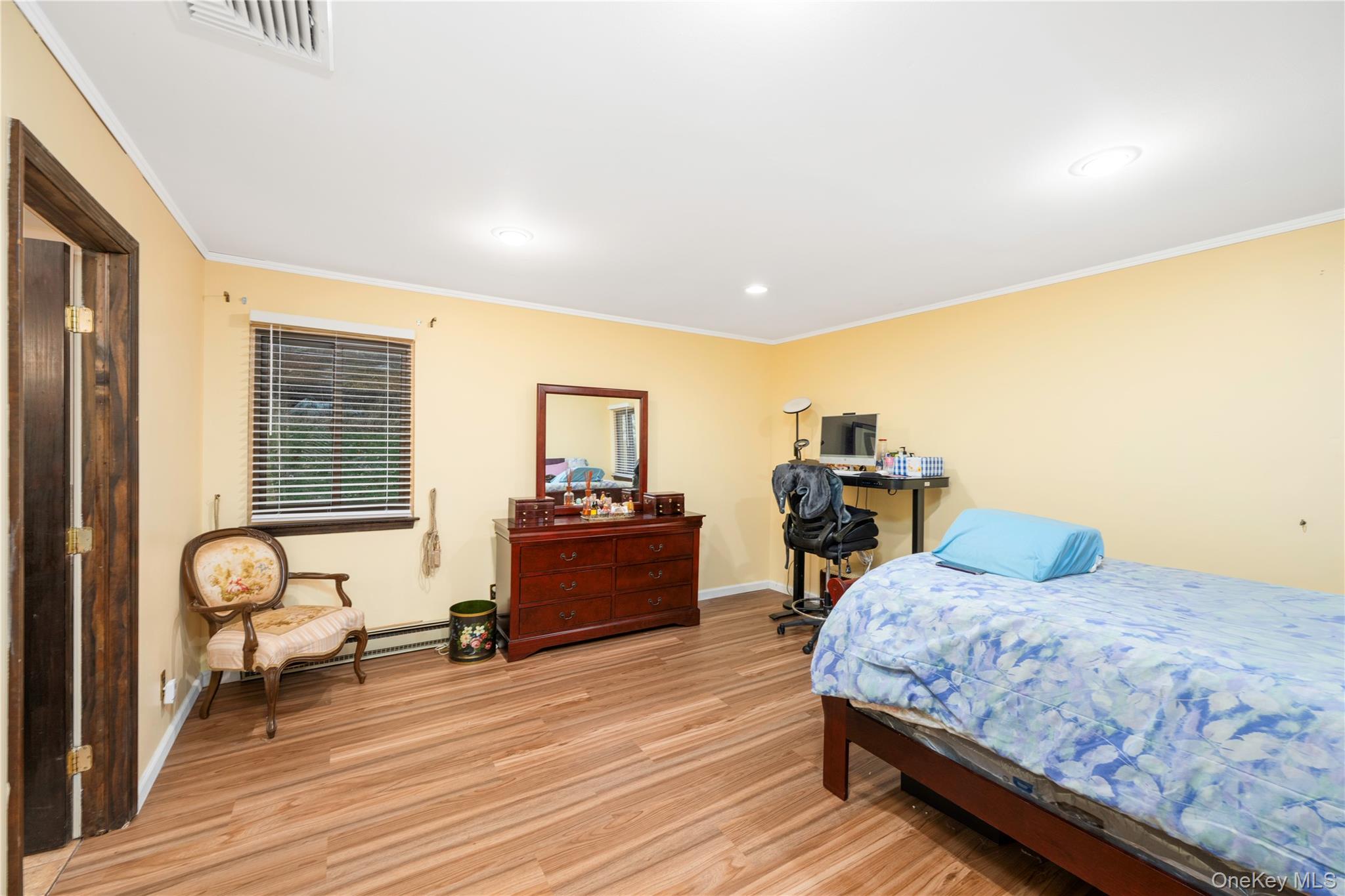 630 Union Valley Road Mahopac, NY 10541 - Photo 14 of 34 a bedroom with a bed and wooden floor