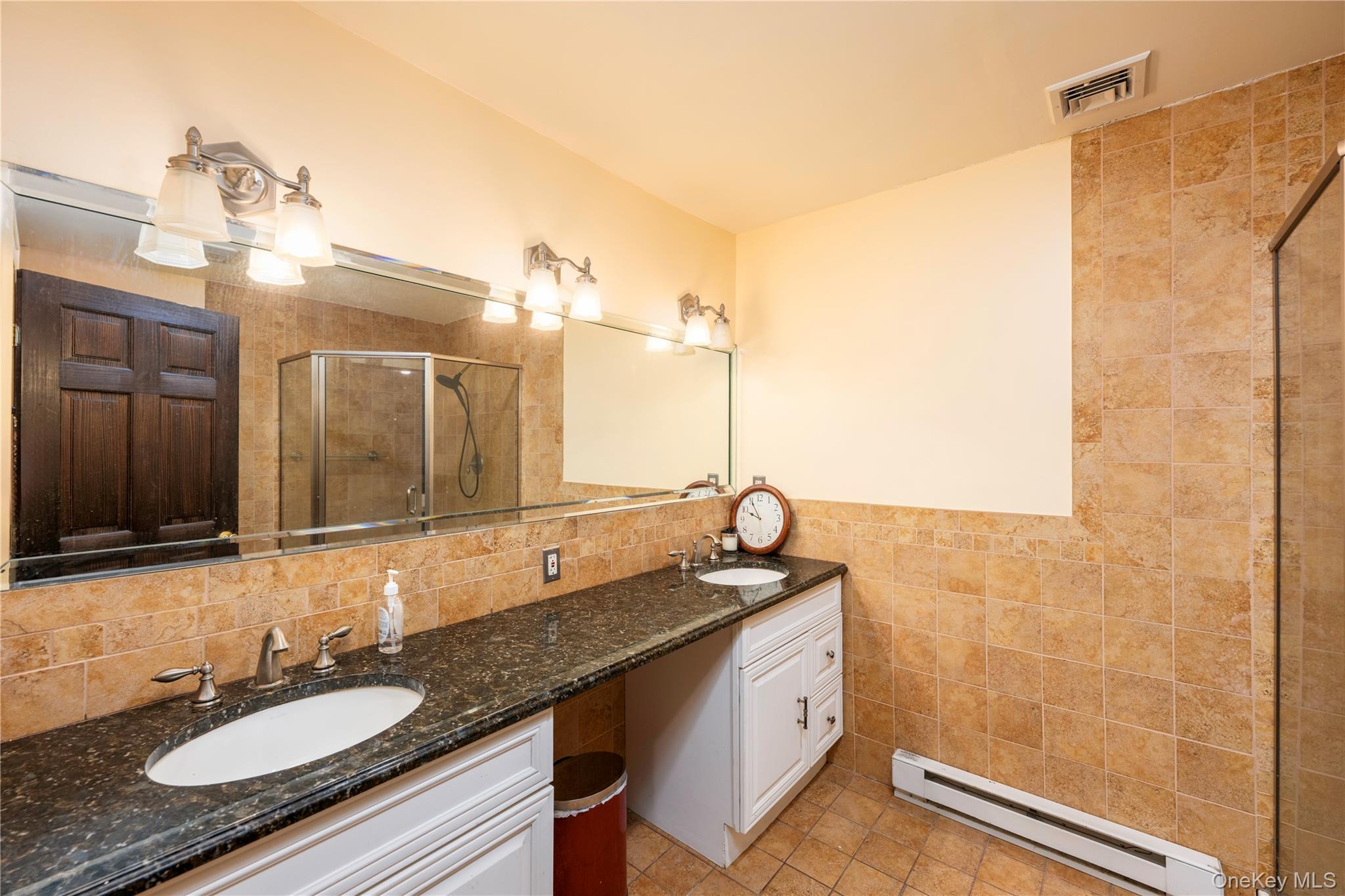 630 Union Valley Road Mahopac, NY 10541 - Photo 15 of 34 a bathroom with a granite countertop sink and a mirror
