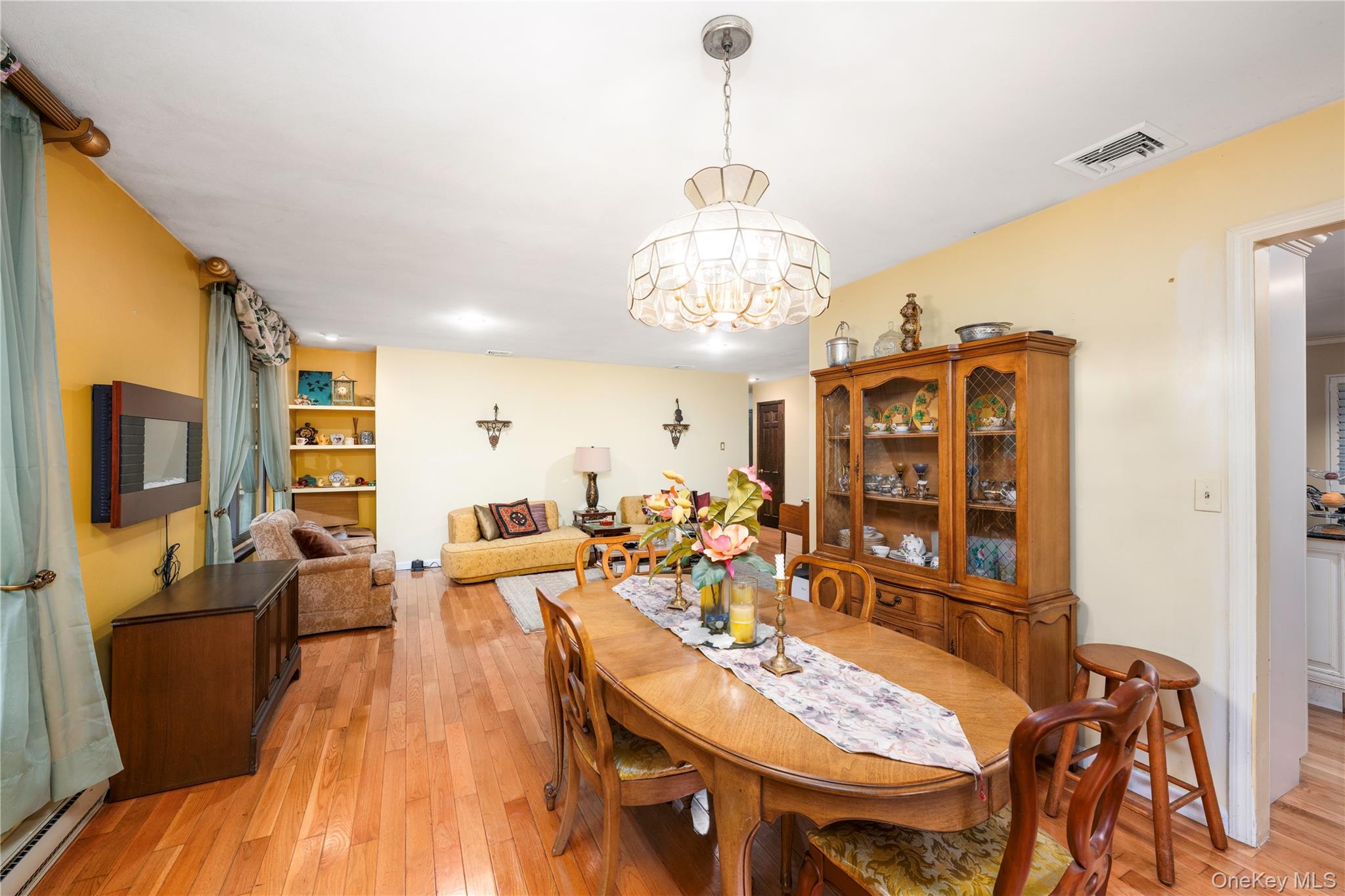 630 Union Valley Road Mahopac, NY 10541 - Photo 7 of 34 a view of a dining room with furniture a chandelier and wooden floor