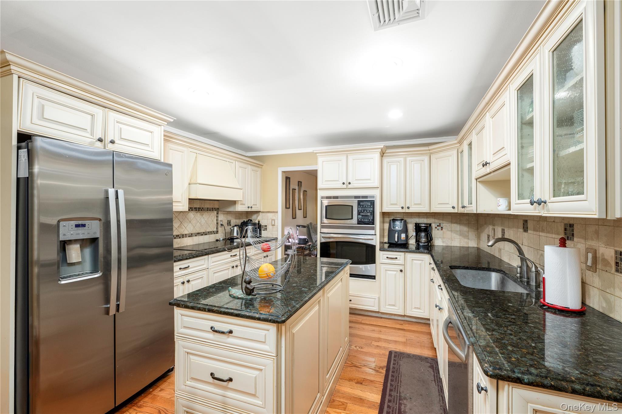 630 Union Valley Road Mahopac, NY 10541 - Photo 8 of 34 a kitchen with stainless steel appliances granite countertop a refrigerator a stove and a sink with cabinets