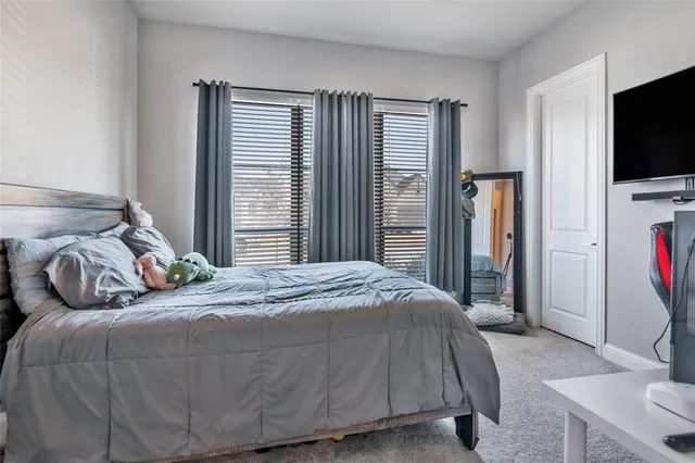 a bedroom with a bed and a flat tv screen