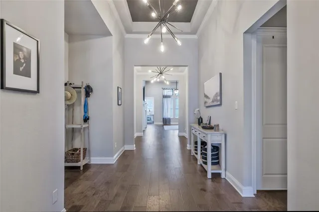 wooden floor in a hall with a chandelier fan