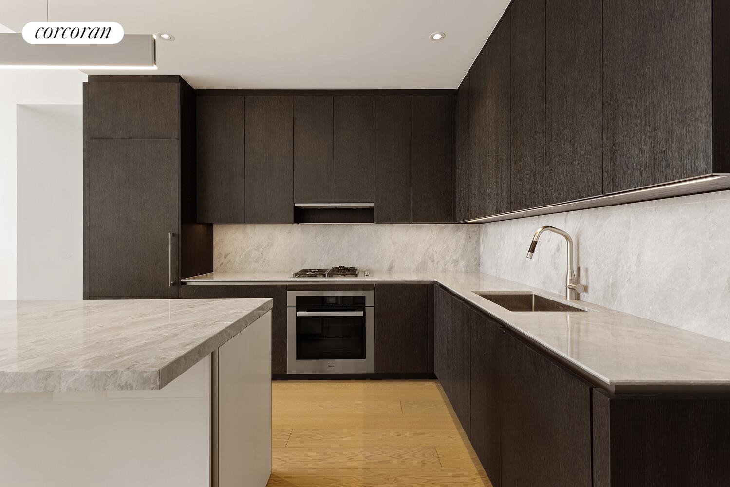 15 Hudson Yards, Unit 72C Manhattan, NY 10001 - Photo 3 of 5 a kitchen with a sink and a stove top oven