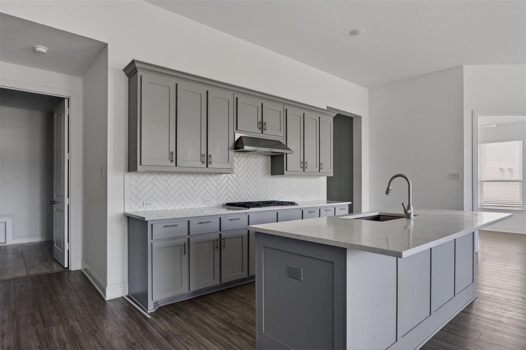 845 Ranchland Road Justin, TX 76247 - Photo 13 of 22 a kitchen with stainless steel appliances granite countertop a sink stove and cabinets