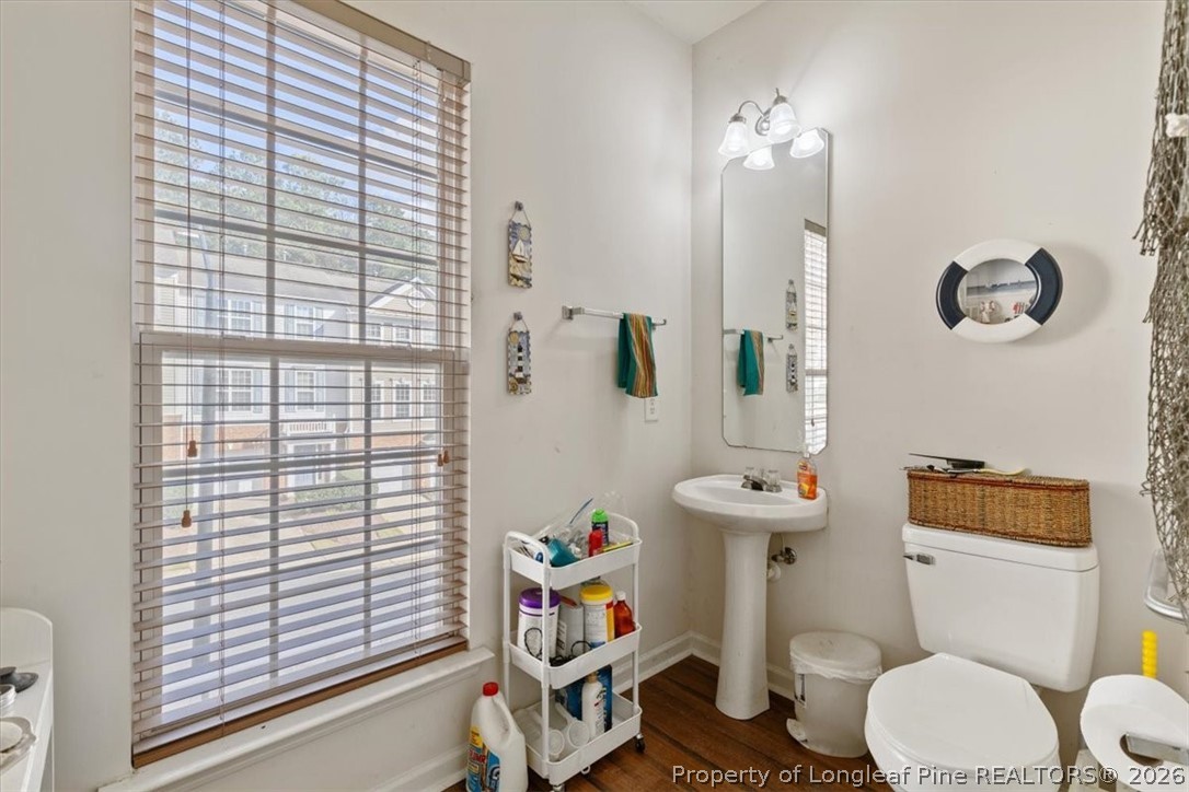 7233 Galon Glen Road Raleigh, NC 27613 - Photo 5 of 6 a bathroom with a sink a toilet and a large mirror