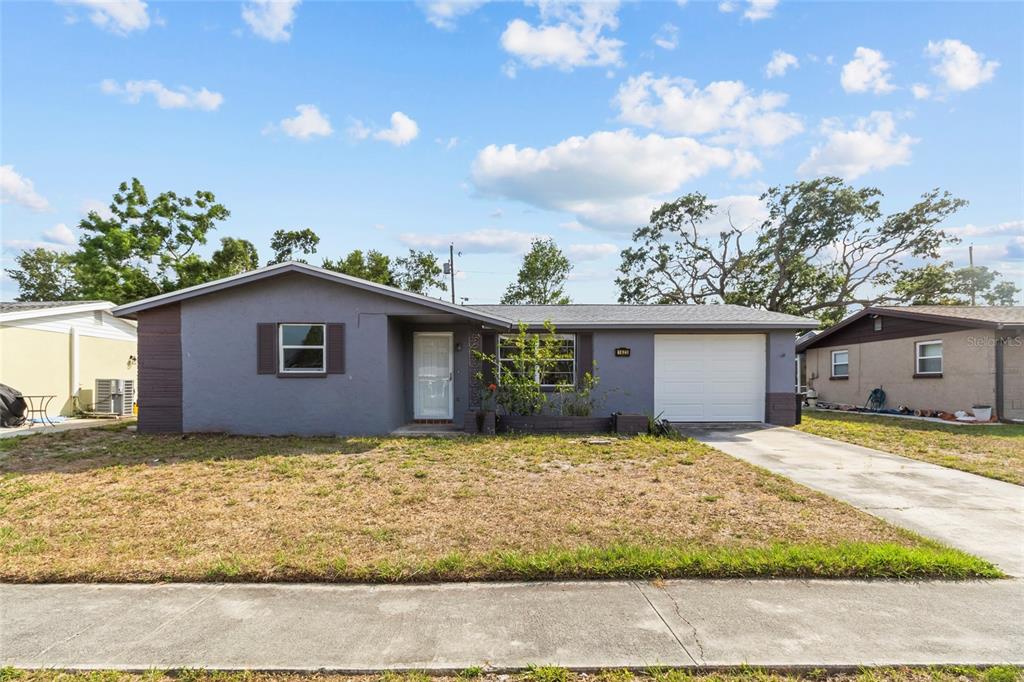 1623 Plum Tree Road Holiday, FL 34690 - Photo 1 of 33 a house with trees in the background