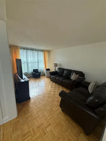a living room with furniture window and a dresser