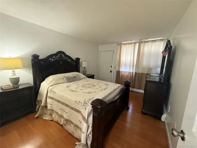 a bed sitting in a bedroom next to a lamp