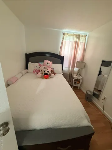 a large bed sitting in a bedroom next to a window