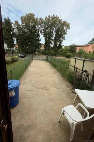 a view of a patio with table and chairs potted plants with lake view