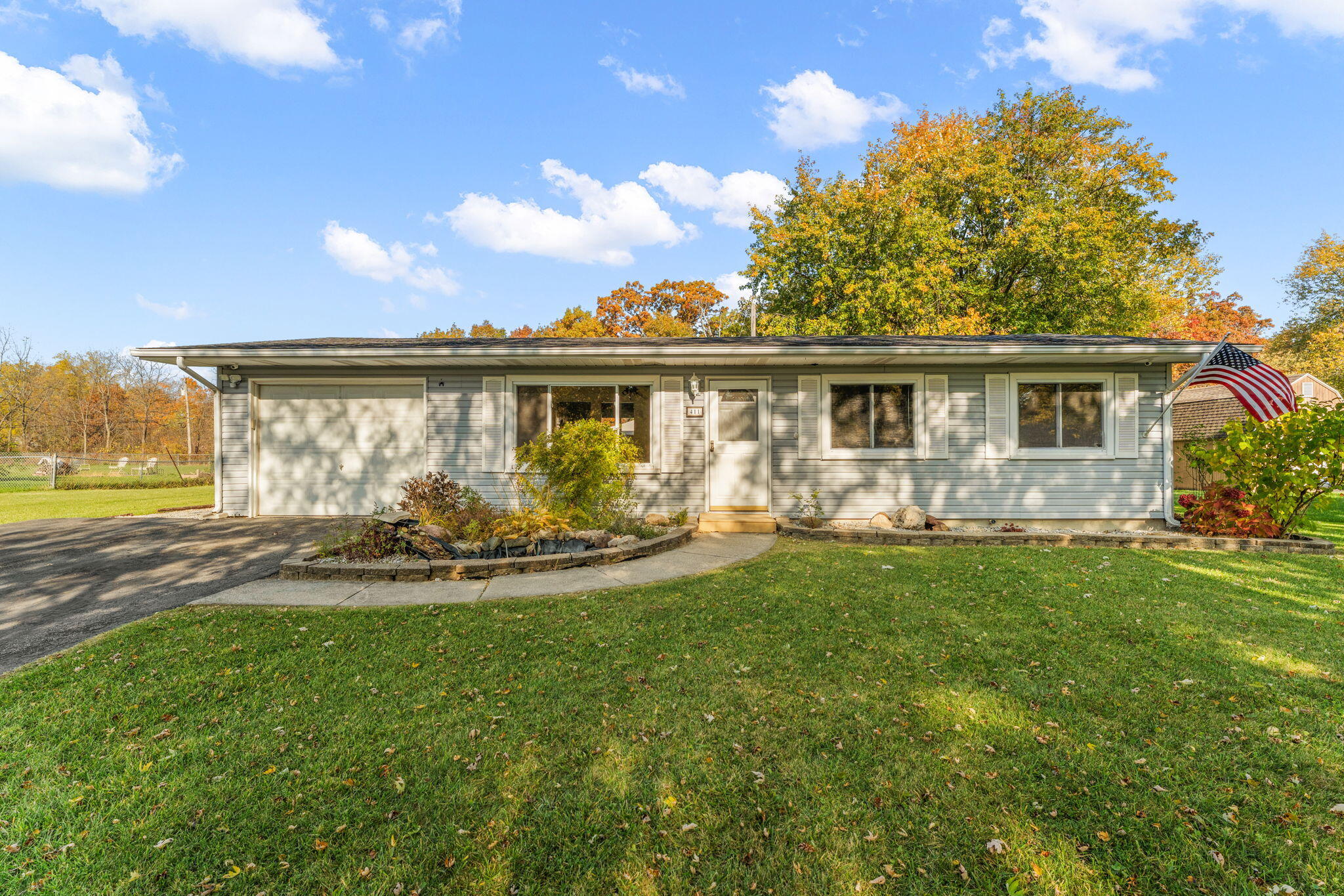 a view of house with backyard and outdoor seating
