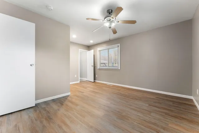 wooden floor in an empty room with a window