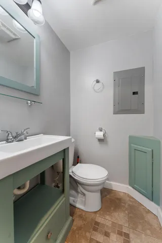 a bathroom with a sink toilet and mirror