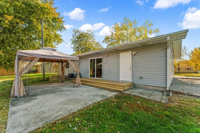 a view of a house with a yard and wooden fence