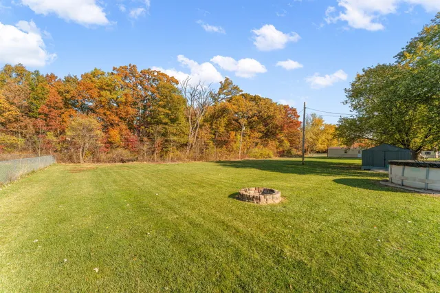 a view of yard with swimming pool and green space