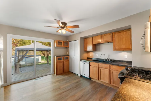 a kitchen with stainless steel appliances granite countertop a stove a sink and a refrigerator