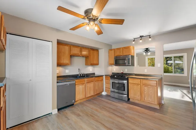 a kitchen with stainless steel appliances granite countertop a stove and a refrigerator