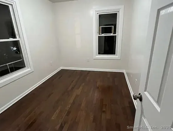 a view of a small space with wooden floor and entryway