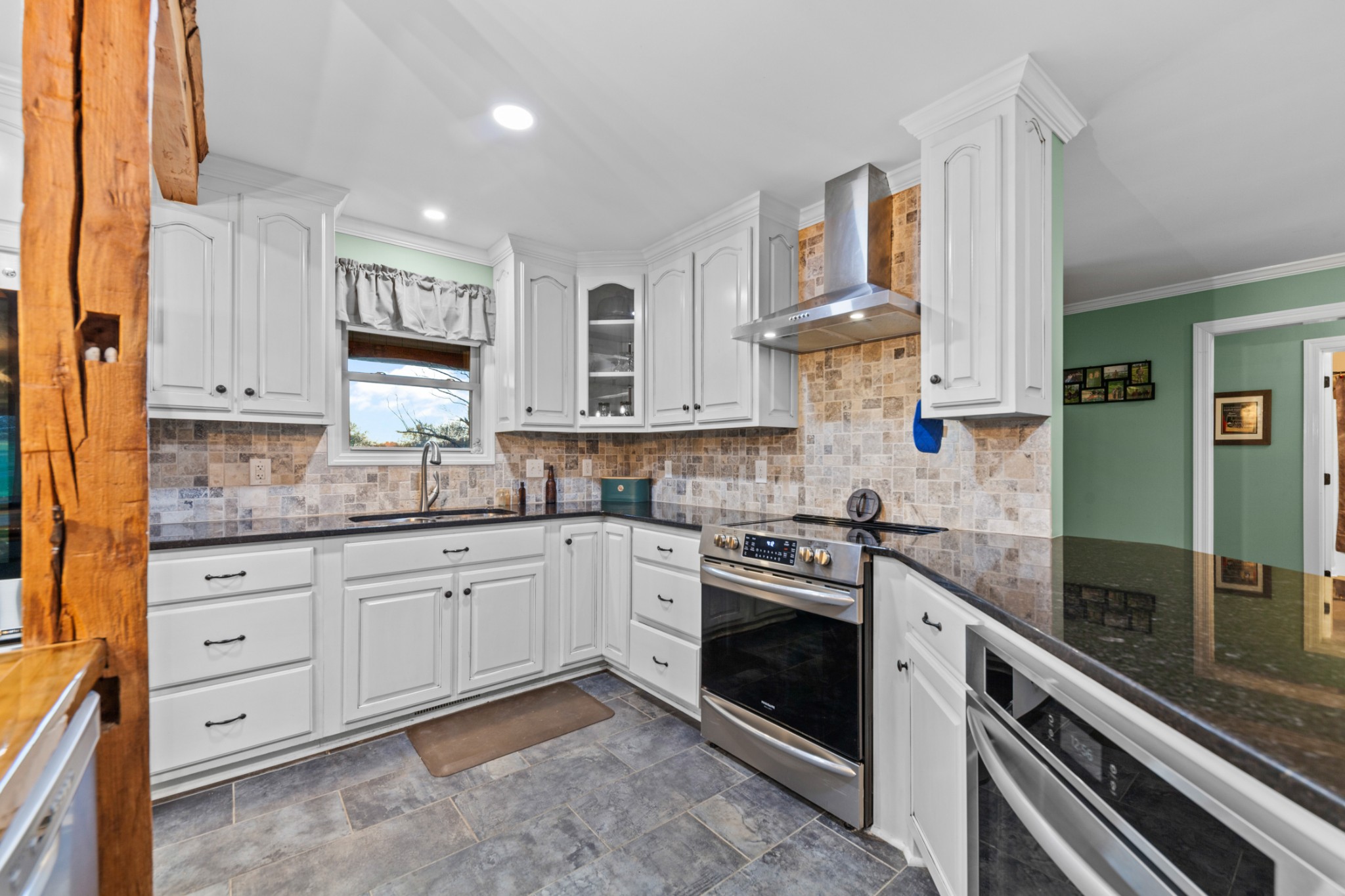 2115 Rock Springs Road Columbia, TN 38401 - Photo 16 of 44 a kitchen with granite countertop a sink stainless steel appliances and cabinets