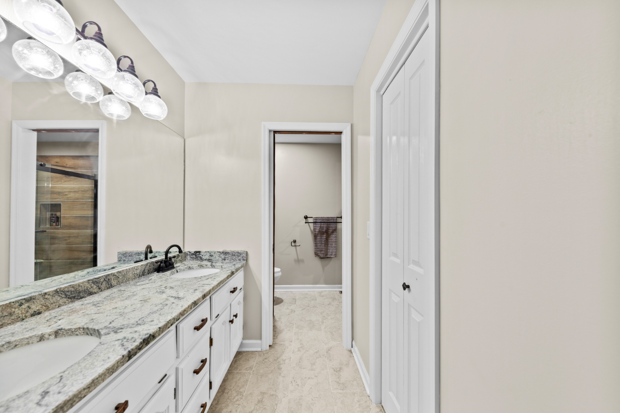 2115 Rock Springs Road Columbia, TN 38401 - Photo 22 of 44 a bathroom with a granite countertop sink a large mirror and a shower