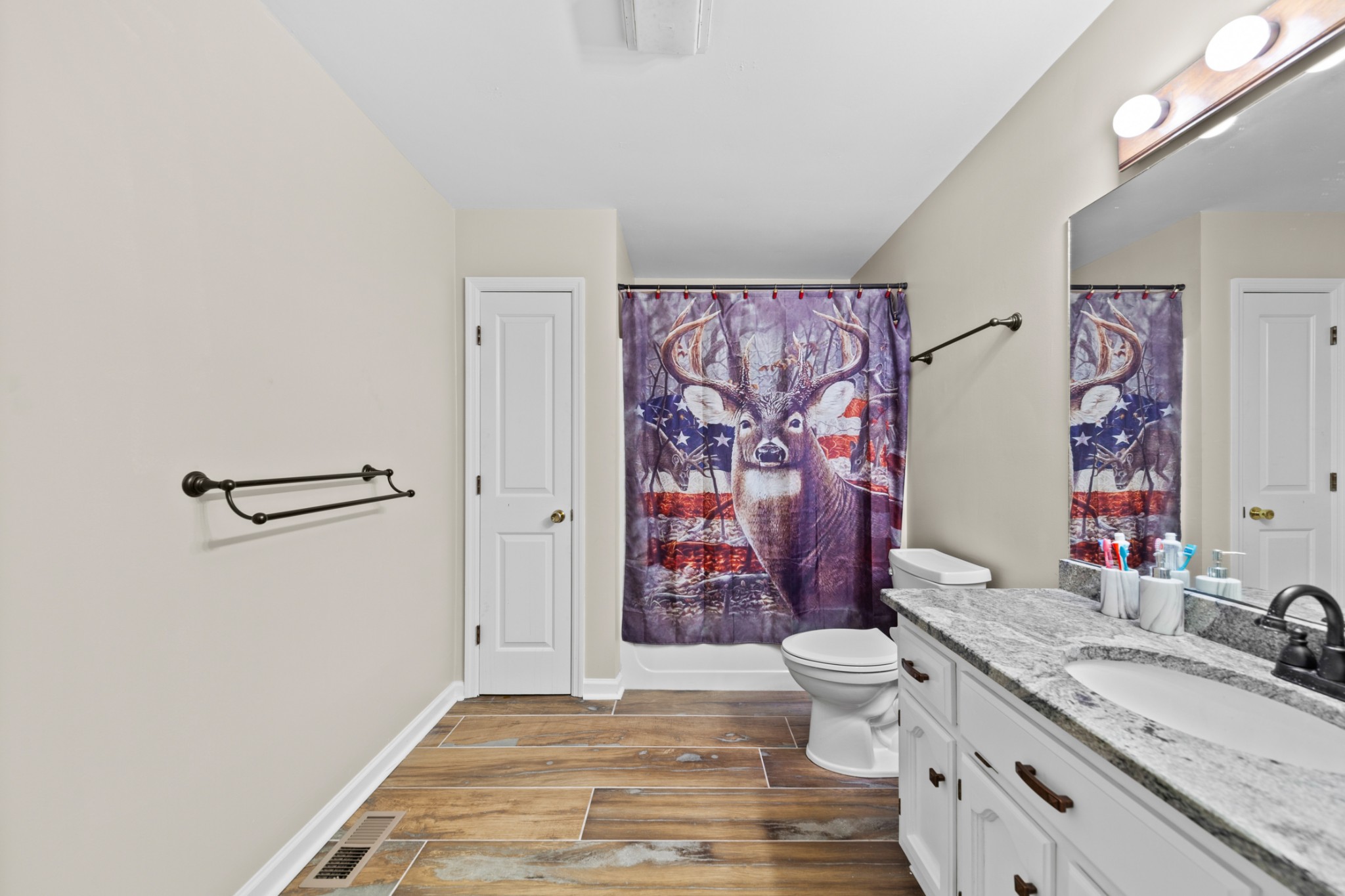 2115 Rock Springs Road Columbia, TN 38401 - Photo 25 of 44 a bathroom with a granite countertop sink a toilet and shower curtain