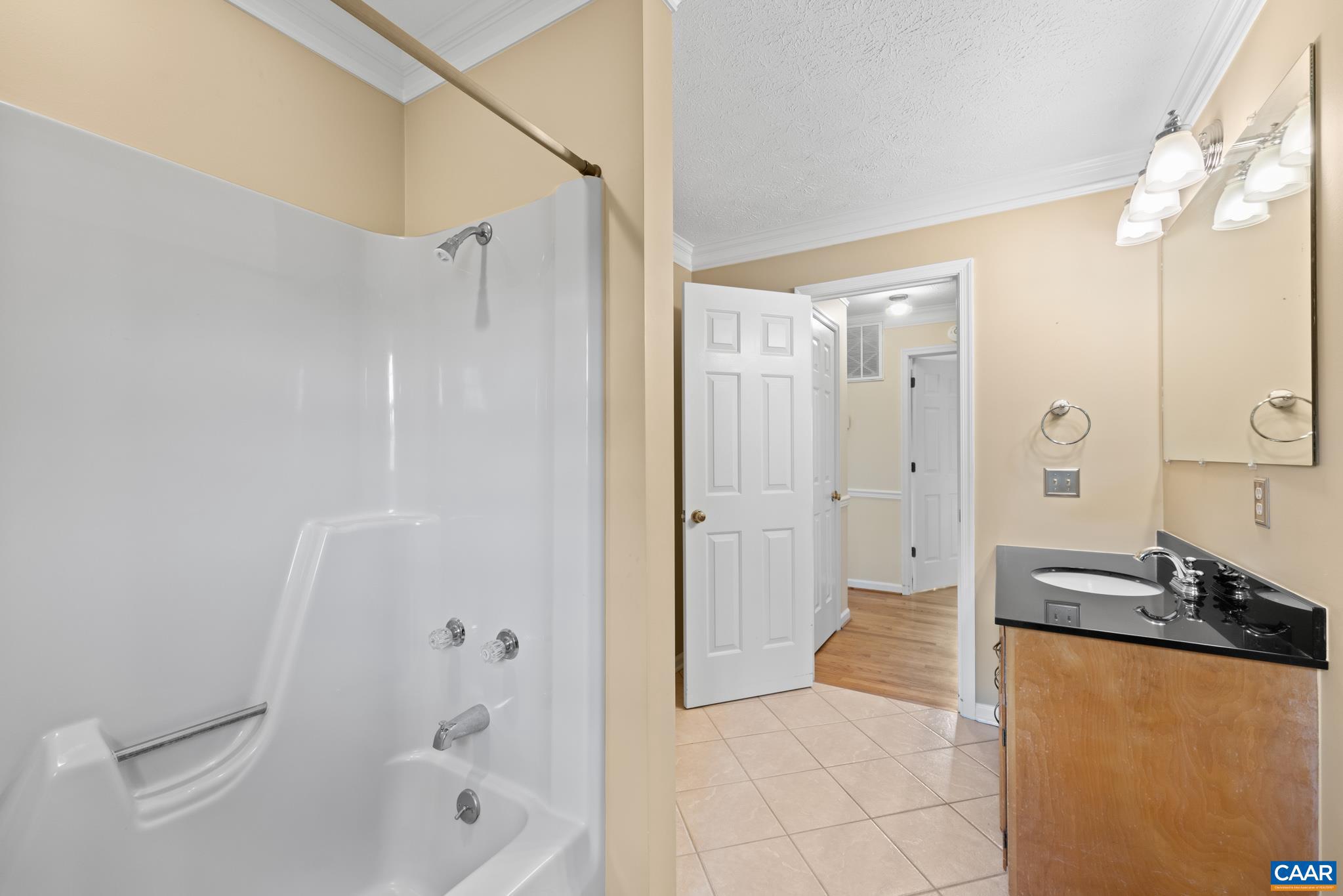 4330 Ridge Road Barboursville, VA 22923 - Photo 14 of 19 a bathroom with a granite countertop sink a mirror a bathtub and shower