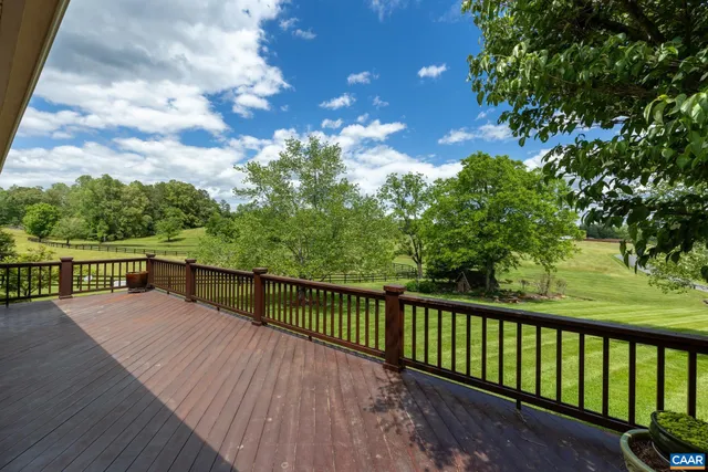 a view of balcony with wooden floor and fence