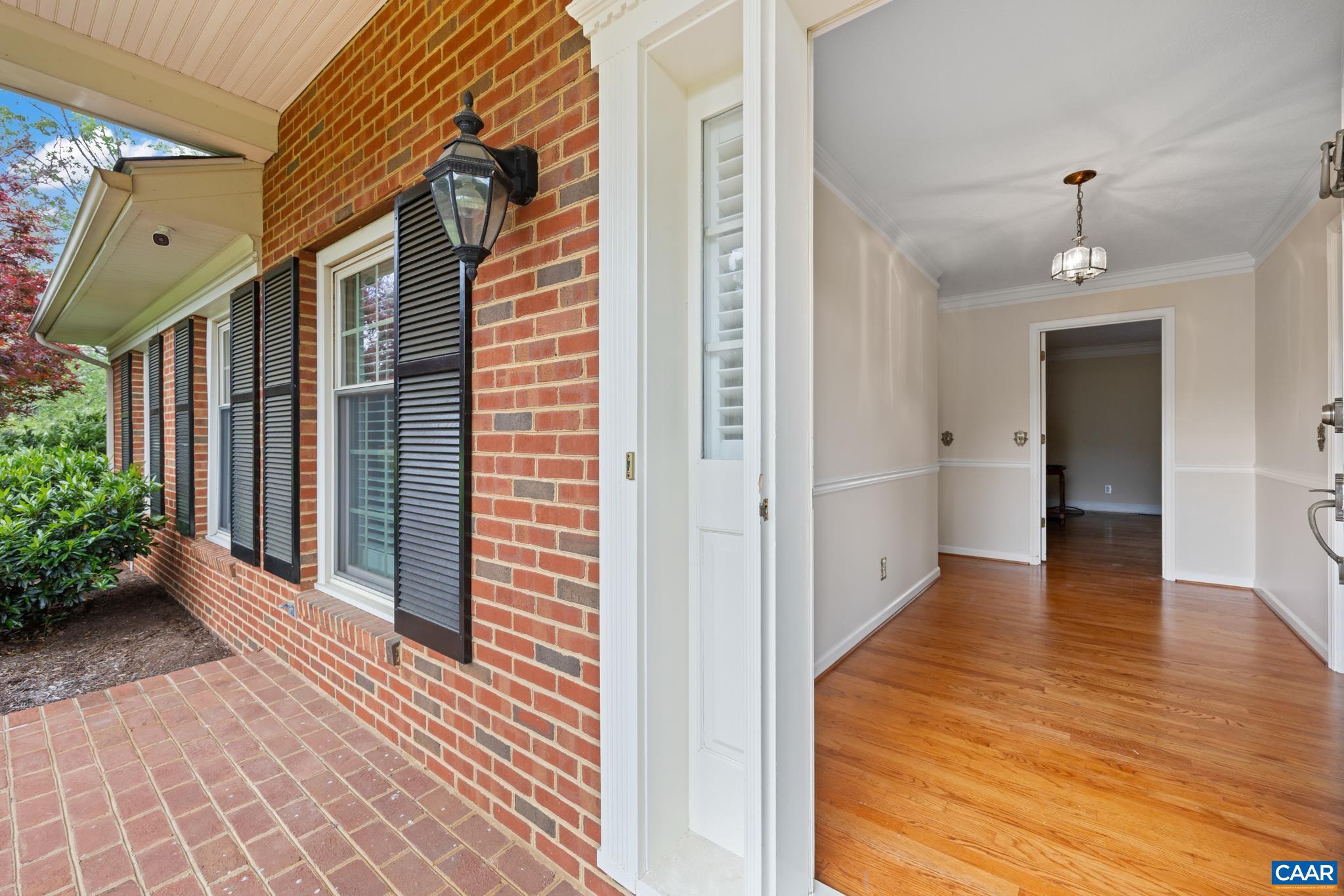 4330 Ridge Road Barboursville, VA 22923 - Photo 3 of 19 a view of a hallway with wooden floor and potted plants
