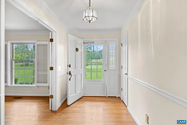 a view of an entryway with wooden floor and door