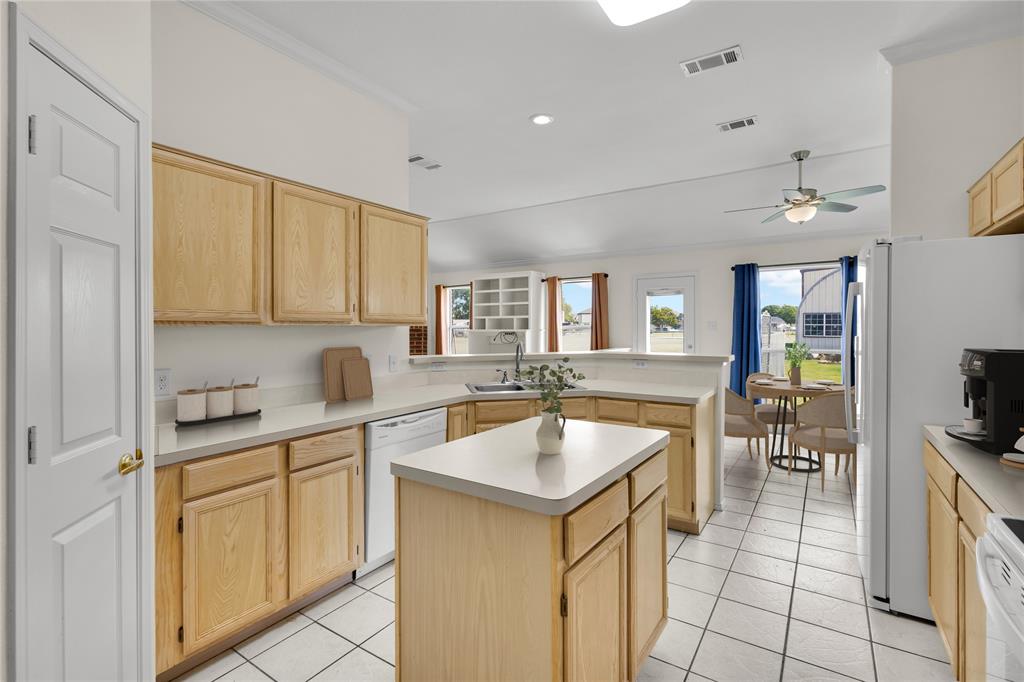 10832 Sky Ridge Court Haslet, TX 76052 - Photo 13 of 40 a kitchen with a sink stove and cabinets